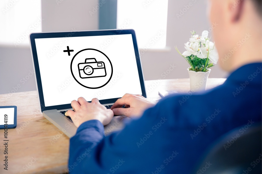 Composite image of businessman using laptop in office