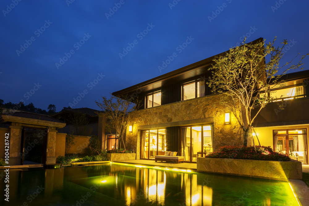 exterior of modern building near pond at night