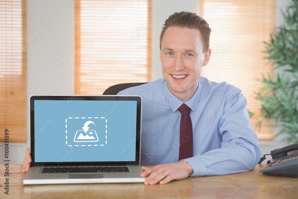 Composite image of happy businessman showing laptop screen