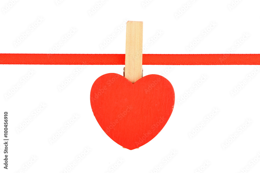 Red wooden heart at ribbon isolated on white