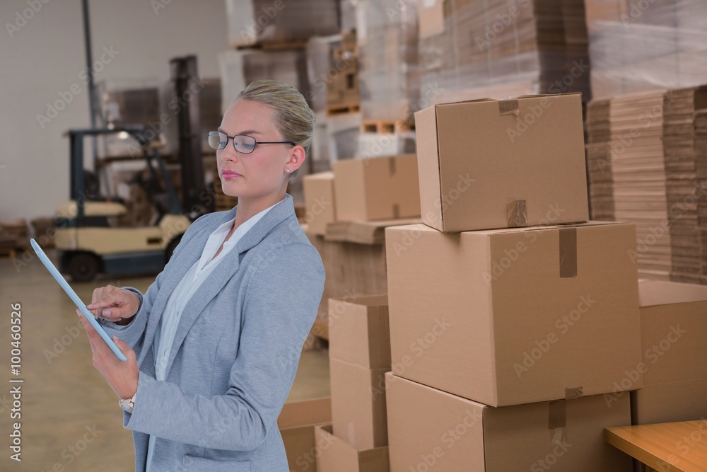 Composite image of businesswoman using digital tablet