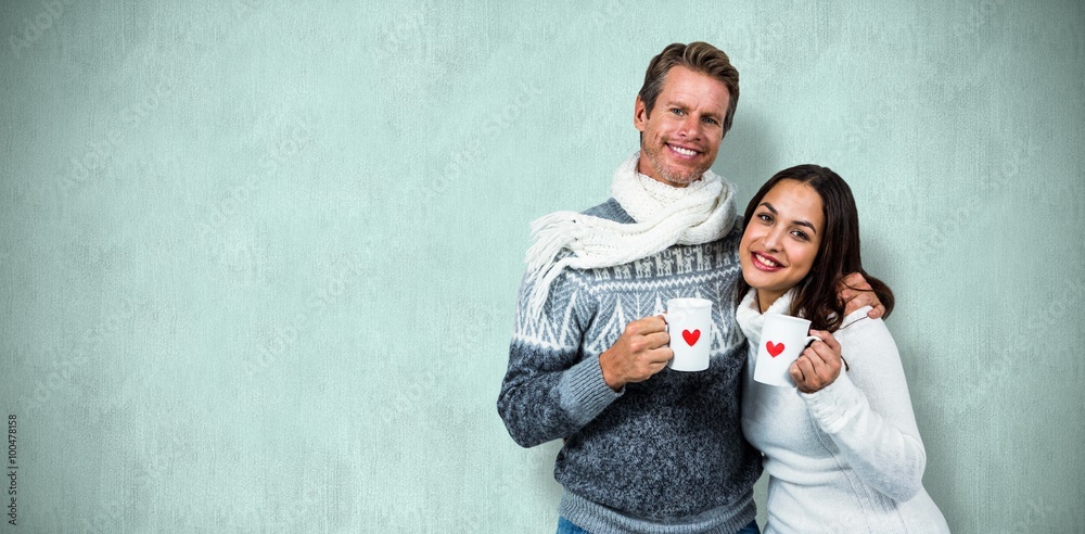 Composite image of festive couple smiling and holding mugs