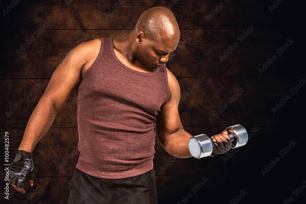 Composite image of fit man exercising with dumbbell 