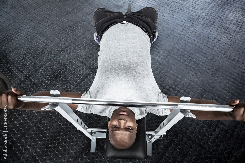 Composite image of fit man exercising with barbell 