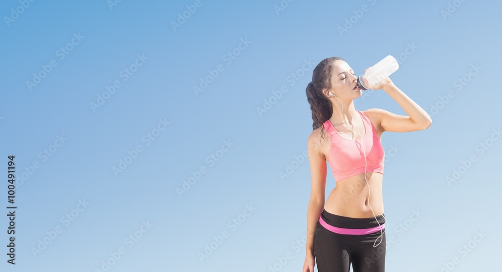 Composite image of beautiful healthy woman drinking water 