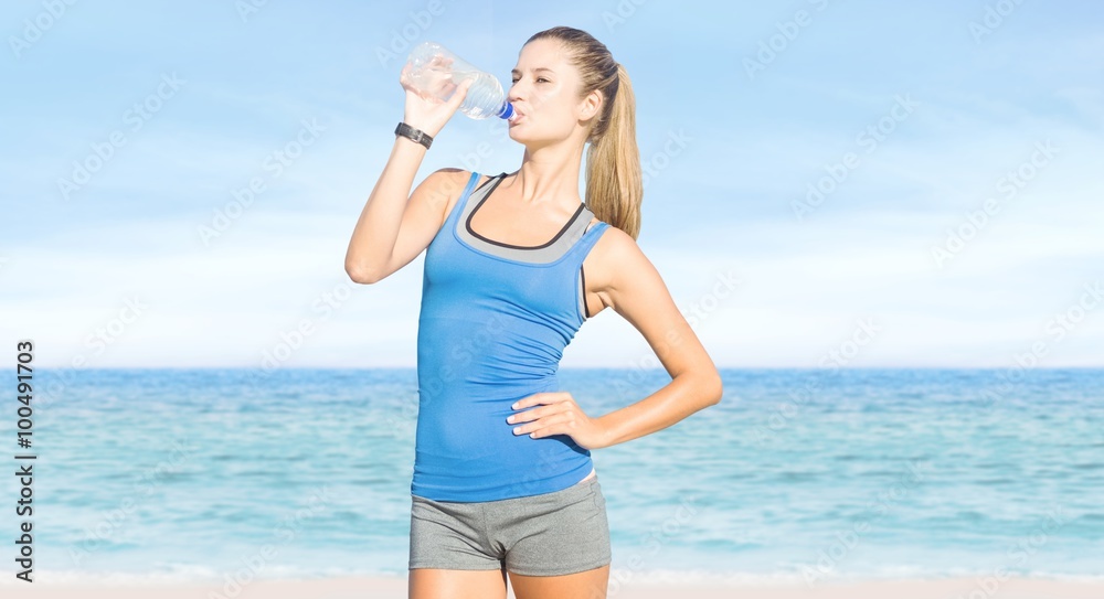 Composite image of fit woman with water