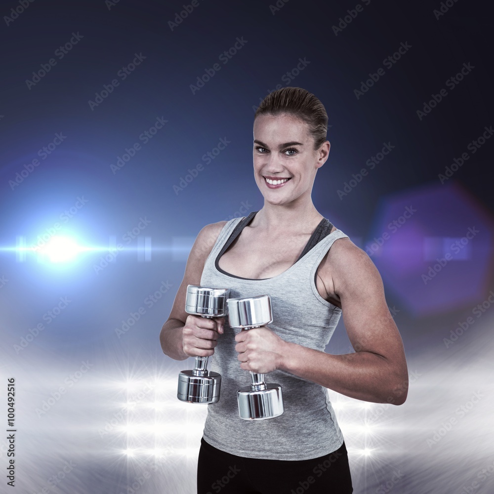 Composite image of  muscular woman working out with dumbbells 