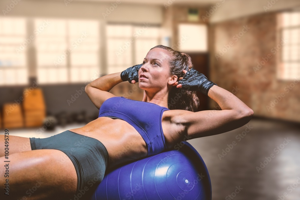 Composite image of woman exercising on ball