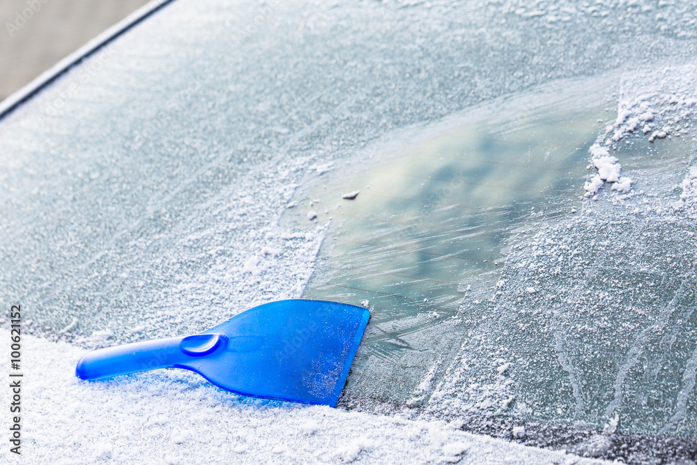 Scraping ice from the car rear windshield window