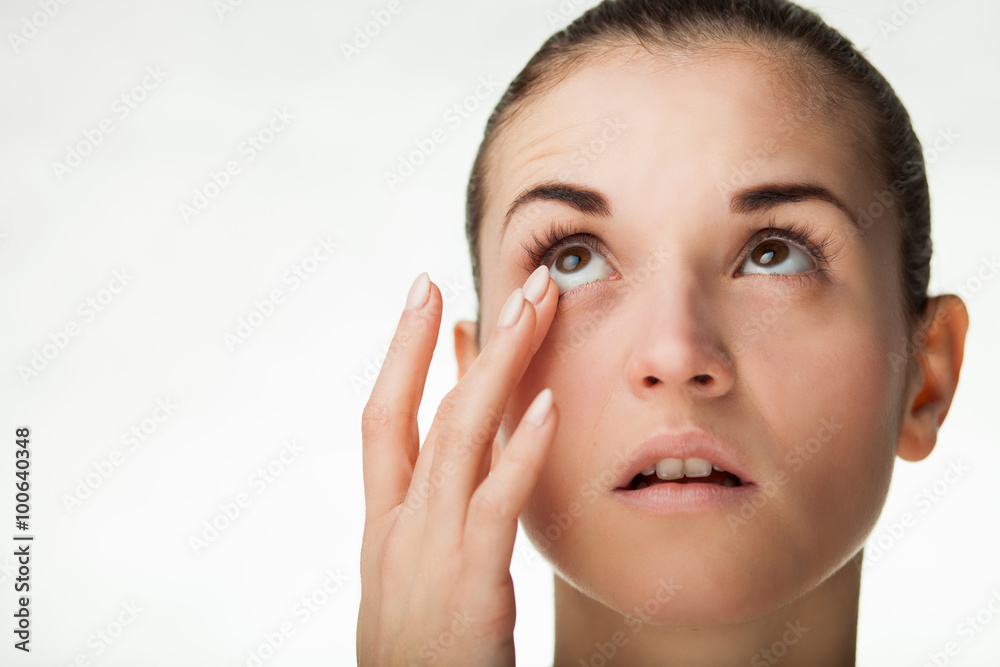 Woman touching her eye concept of healthcare