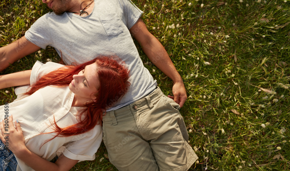 Young couple relaxing on the grass.