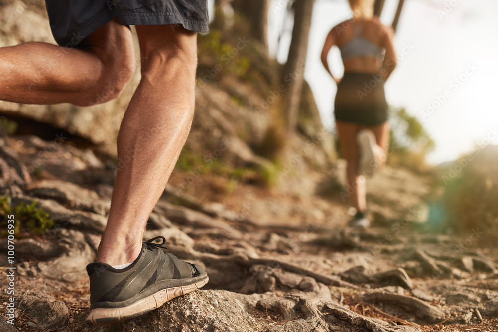 Athletes run through rocky terrain