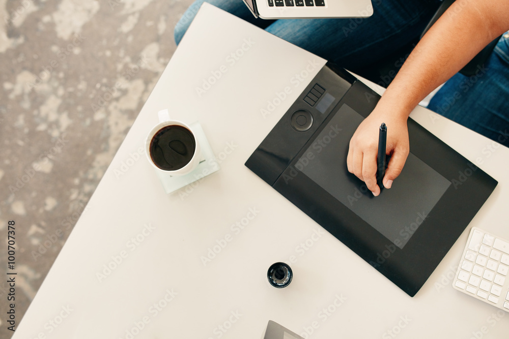 Man using a stylus and graphics tablet.