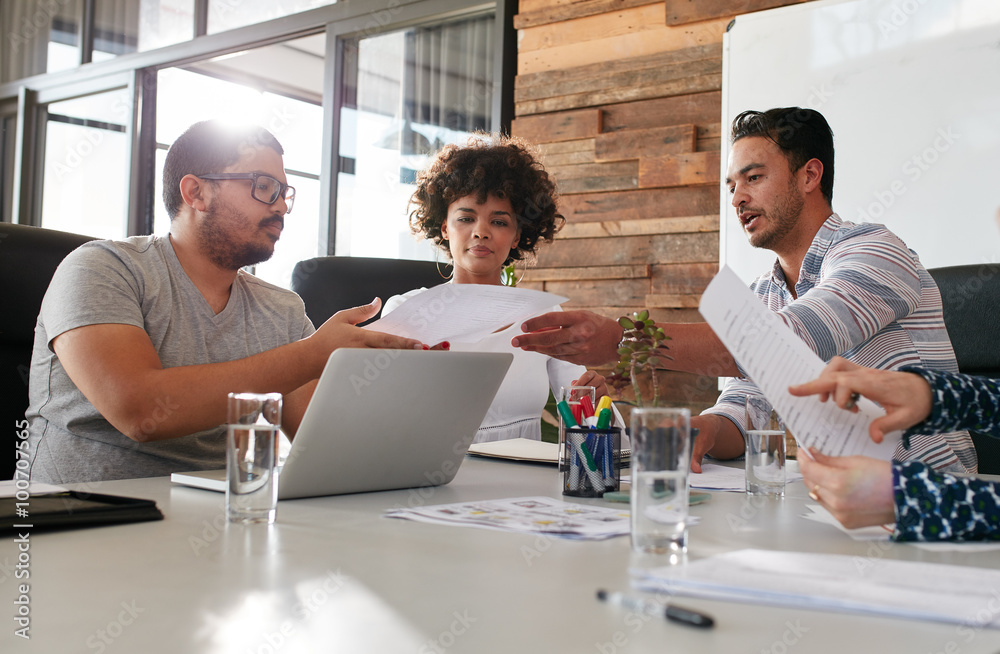 Young office workers discussing work in a boardroom