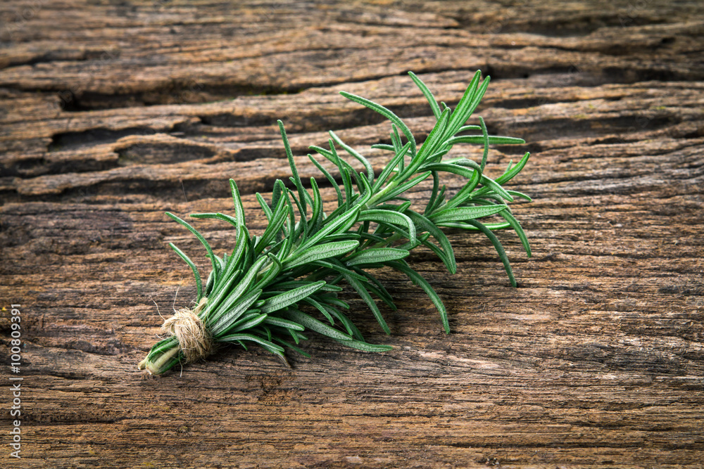 Fresh green Rosemary bound on a wooden board