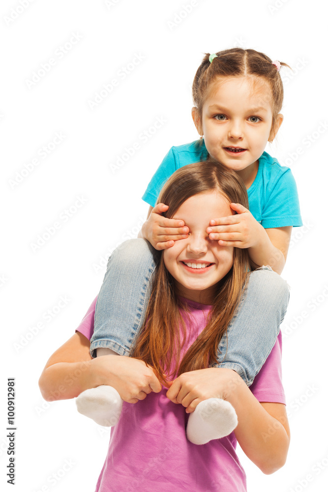 Little sister sitting on elder sisters shoulders