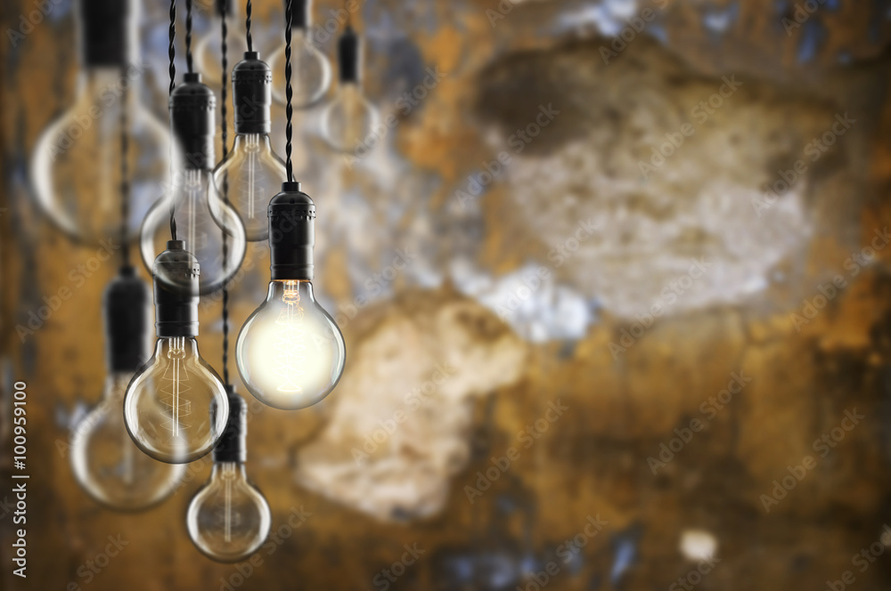 Idea and leadership concept Vintage  bulbs on wall background