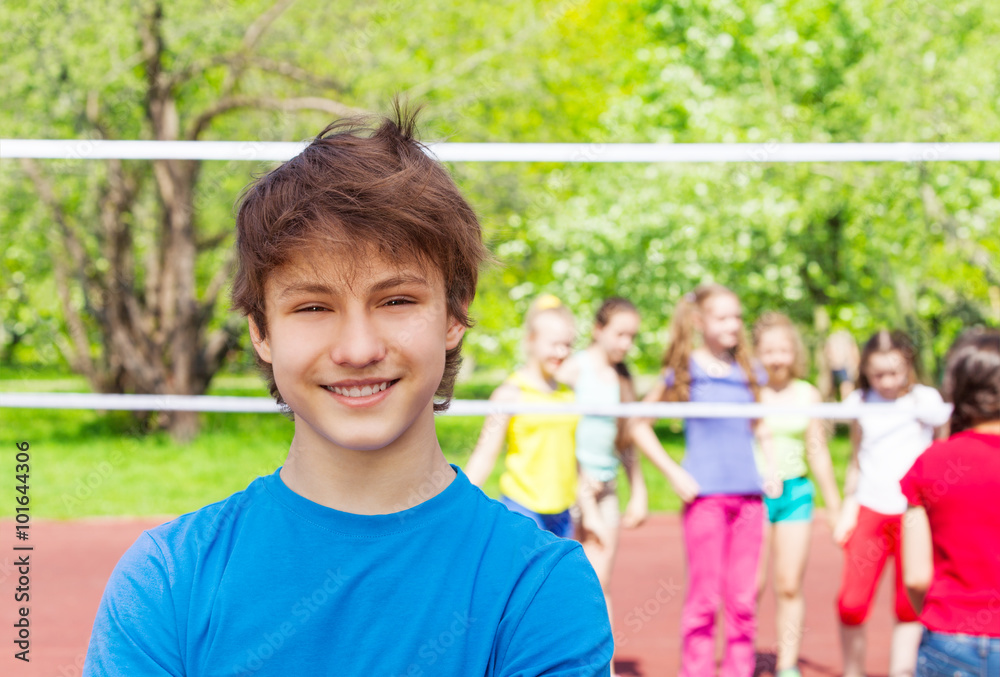 Happy teenager boy on playground during volleyball