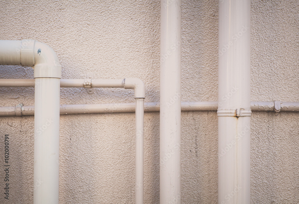 Pipeline water detail at industrial building wall