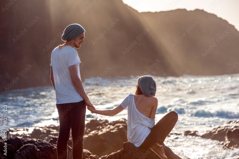 Couple together on the rocky coast