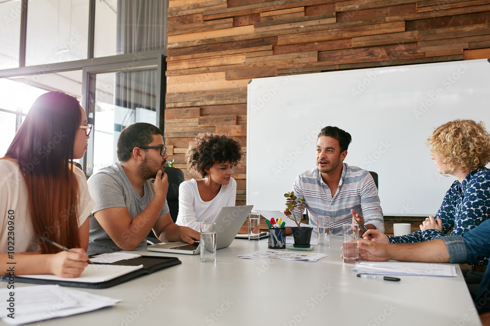 Group of young business professionals having a meeting