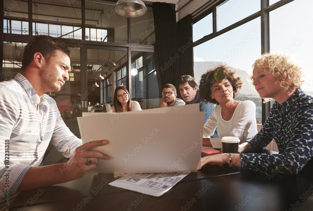 Colleagues sitting in a meeting to work out business plans