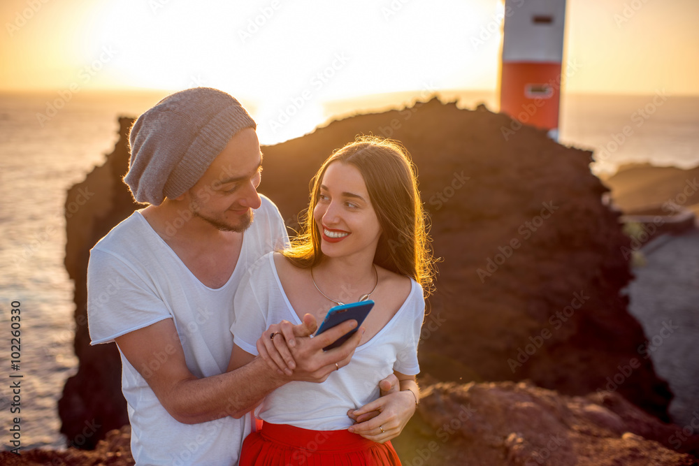 Couple enjoying summer vacation near the lighthouse