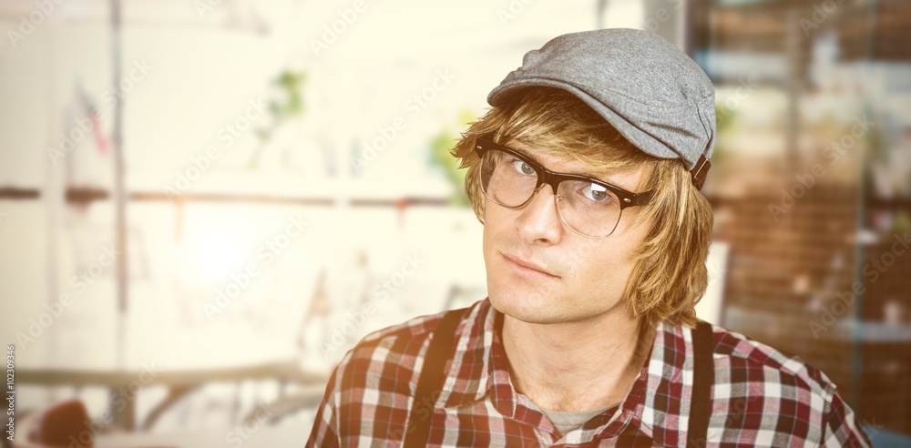 Composite image of serious blond hipster staring