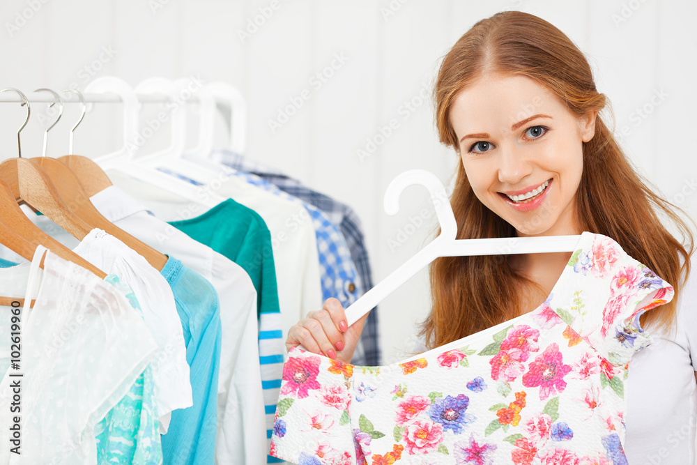 woman chooses clothes in her wardrobe