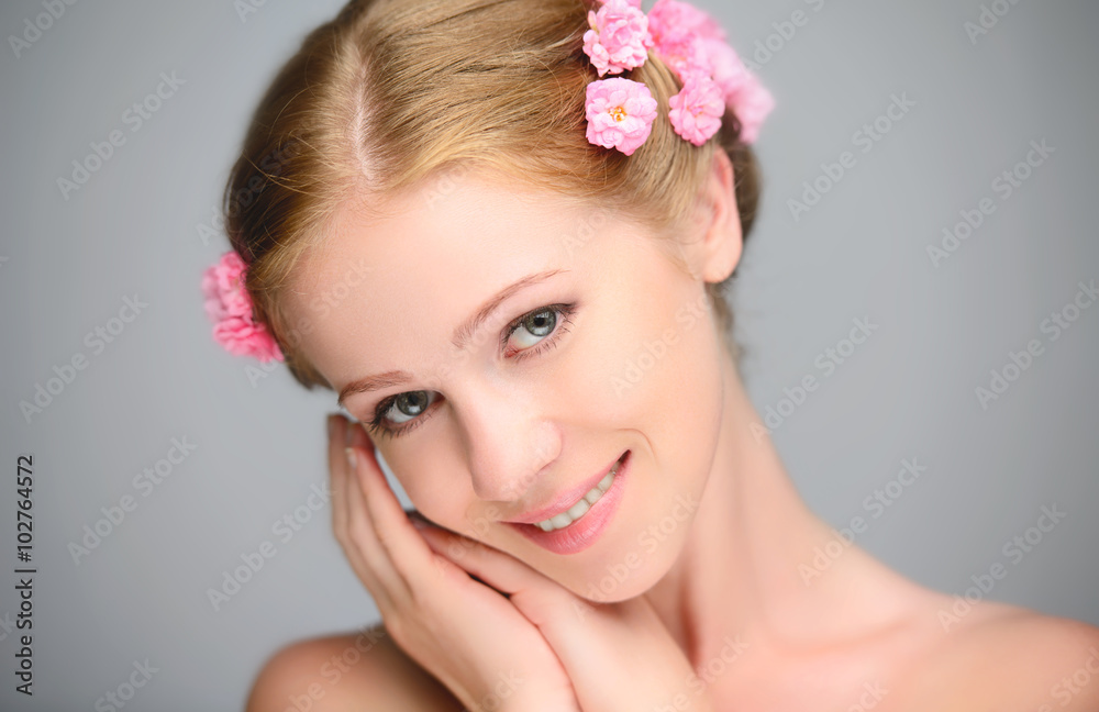 Beauty face of young beautiful woman with pink flowers