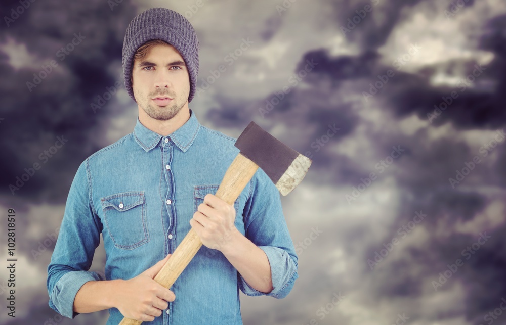 Composite image of portrait of serious hipster holding axe