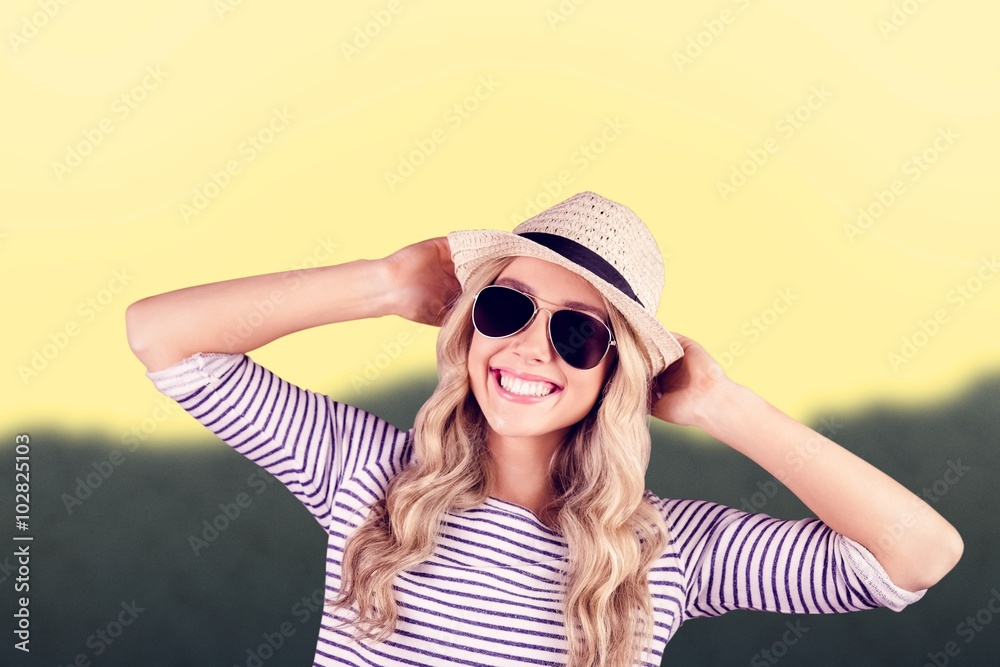 Composite image of gorgeous smiling blonde hipster posing