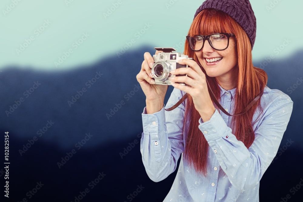 Composite image of smiling hipster woman taking pictures