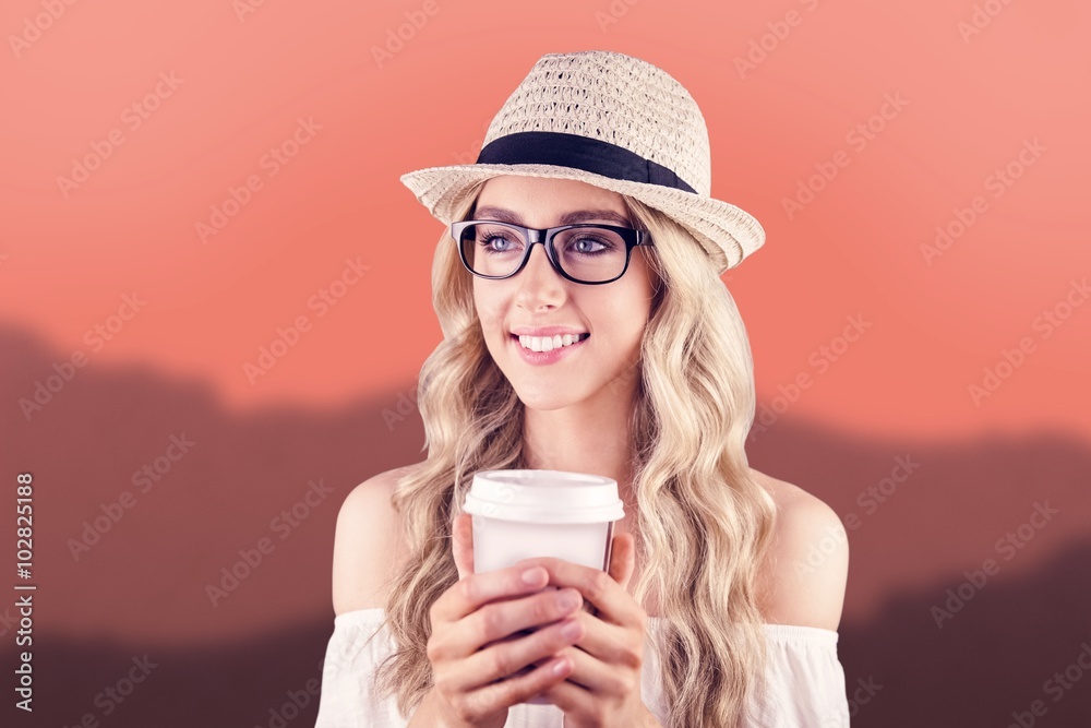 Composite image of blonde hipster holding coffee