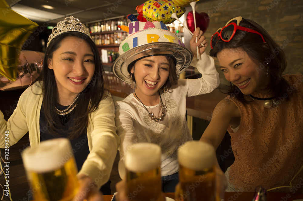 Women are toast with beer birthday of friend