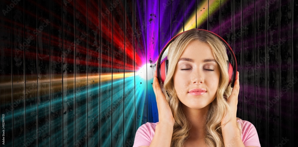 Composite image of close up of a woman listening to music 