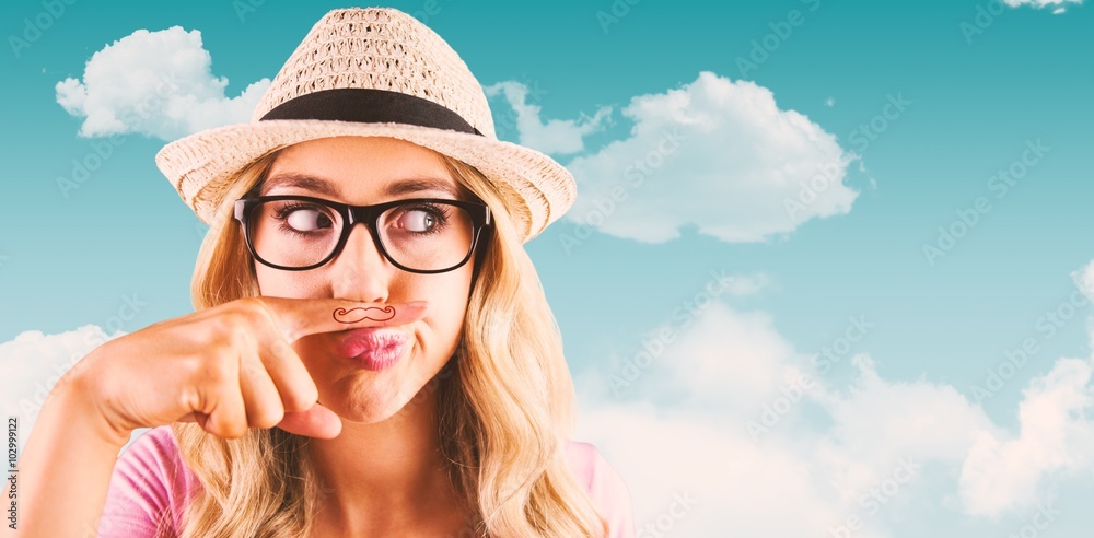 Composite image of a beautiful hipster having a fake mustache 