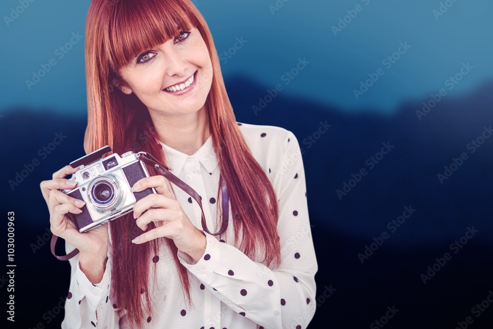 Composite image of smiling hipster woman with retro camera