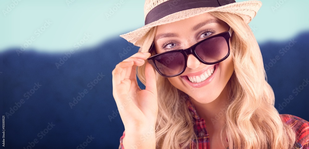 Composite image of gorgeous smiling blonde hipster posing