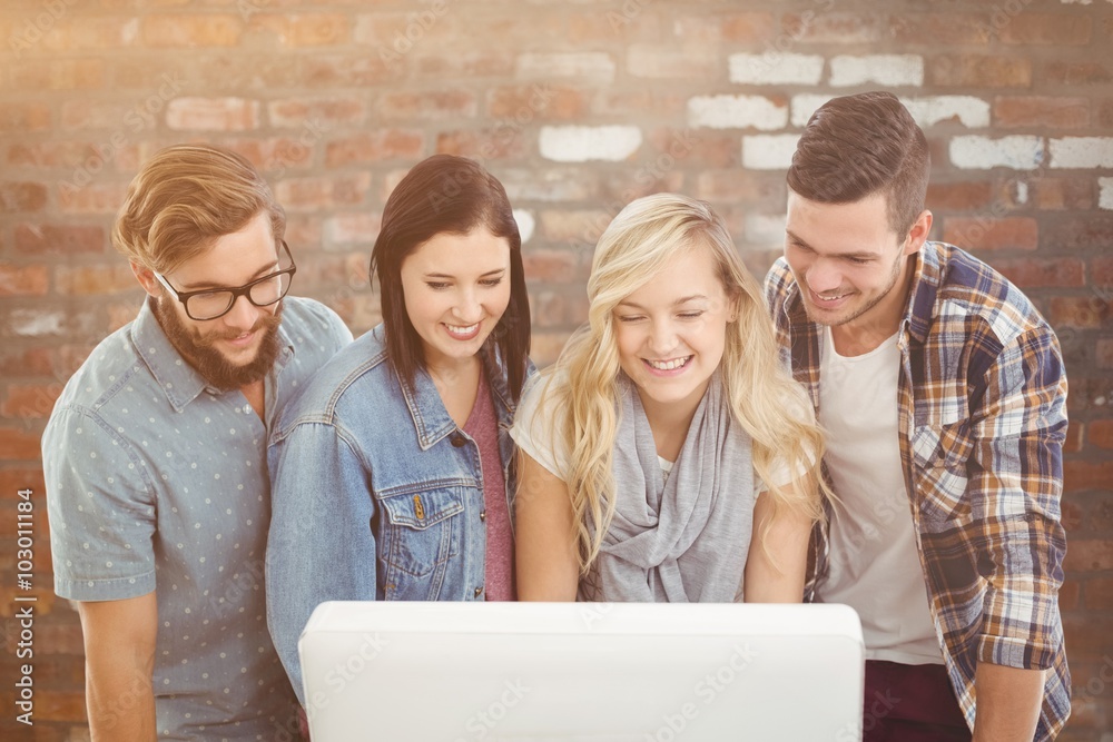 Composite image of smiling business people working on computer 