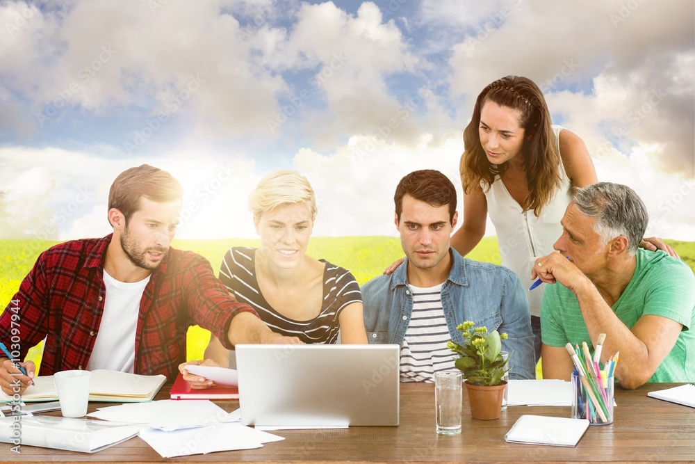 Composite image of teamwork using laptop together