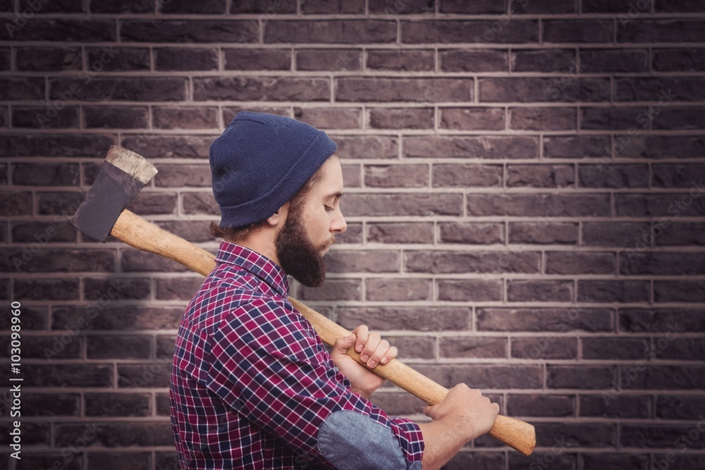 Composite image of side view of hipster with axe