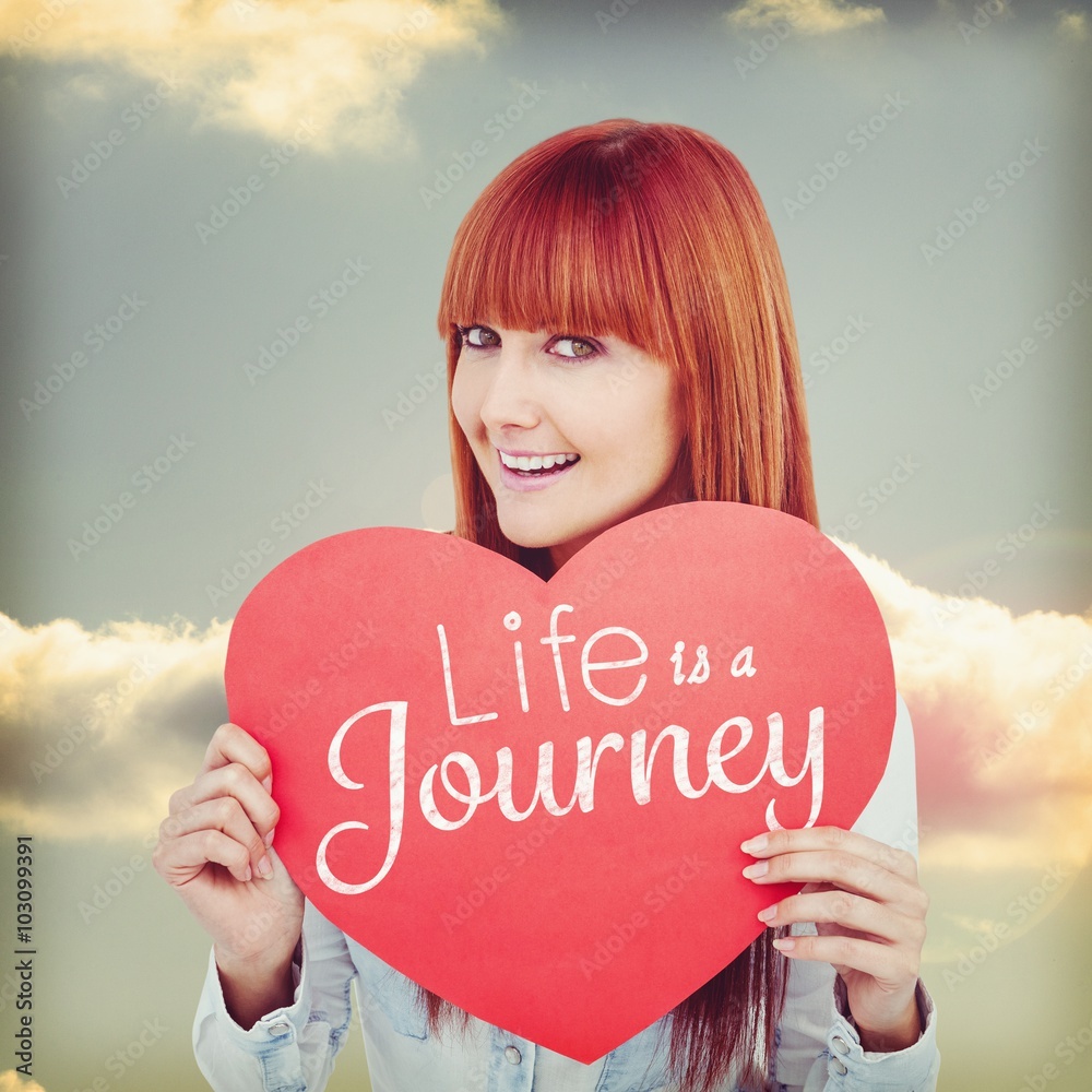 Composite image of attractive hipster woman behind a red heart