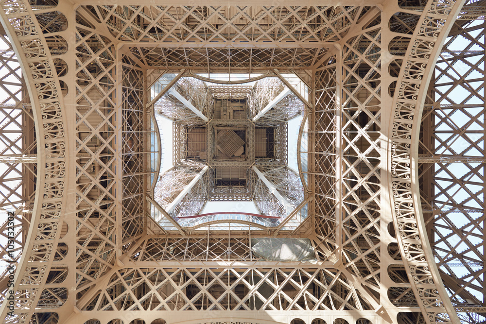 Eiffel tower structure under view in Paris, sunny day