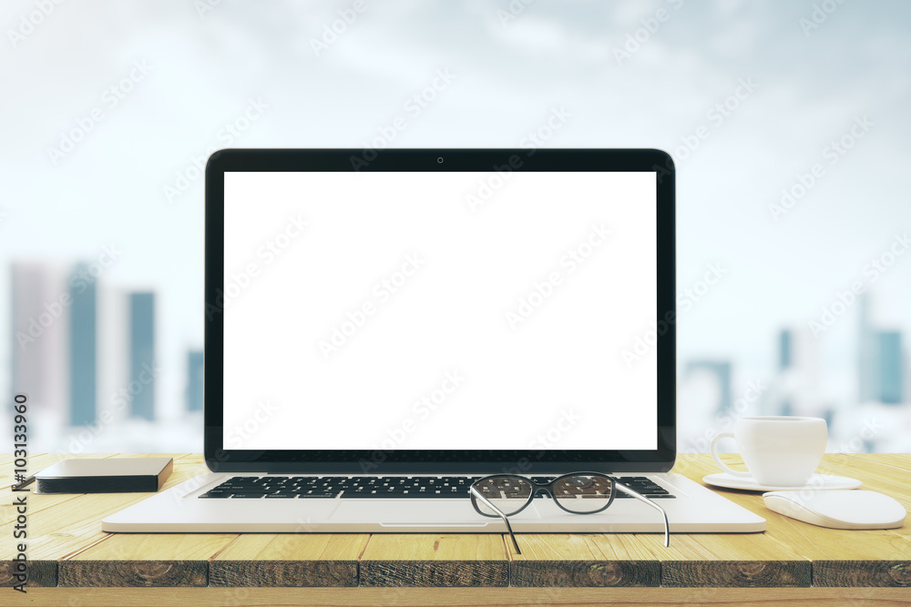 Blank laptop screen on the wooden table with cup of coffee and g