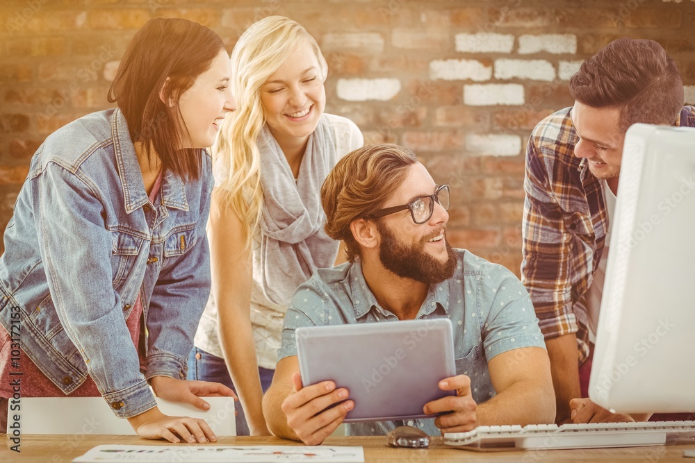 Composite image of happy business people using digital tablet