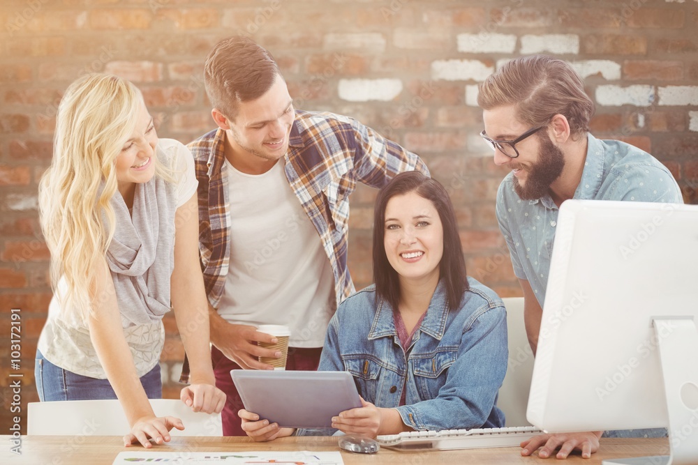 Composite image of cheerful business professionals using tablet