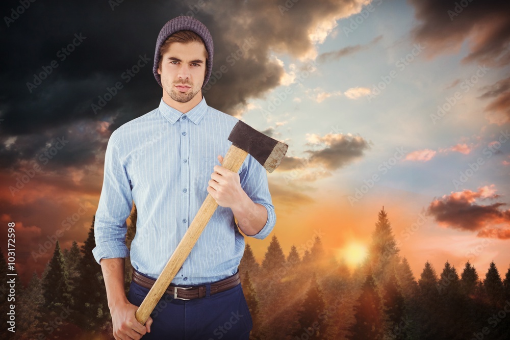 Composite image of portrait of serious hipster holding axe