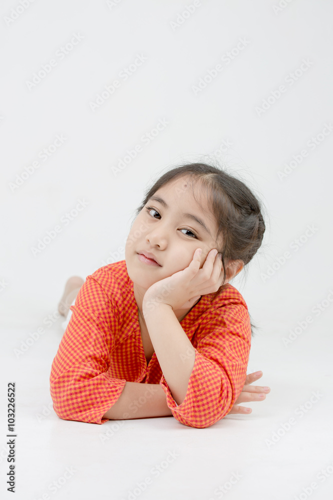 Little Asian girl lying on the floor on isolated