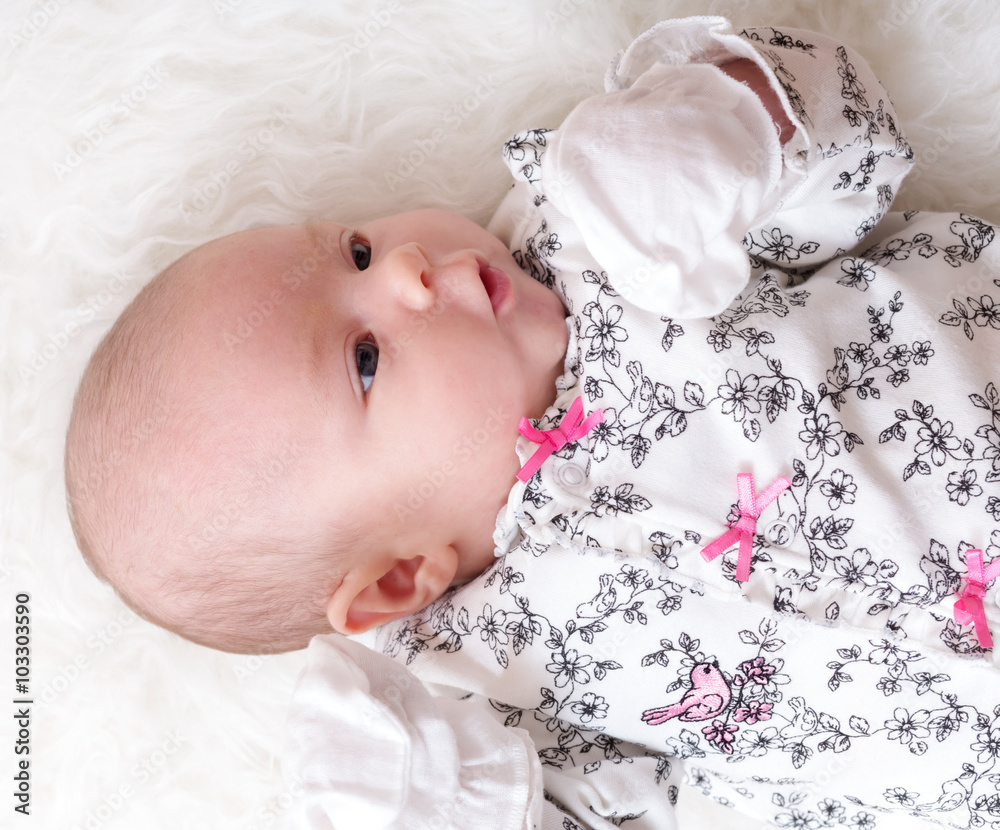 Newborn baby laying on her blanket